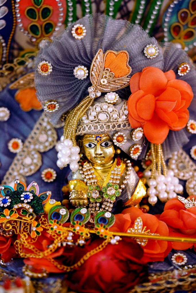 Beautifully adorned Hindu deity idol with vibrant decorations in Unjha, Gujarat.